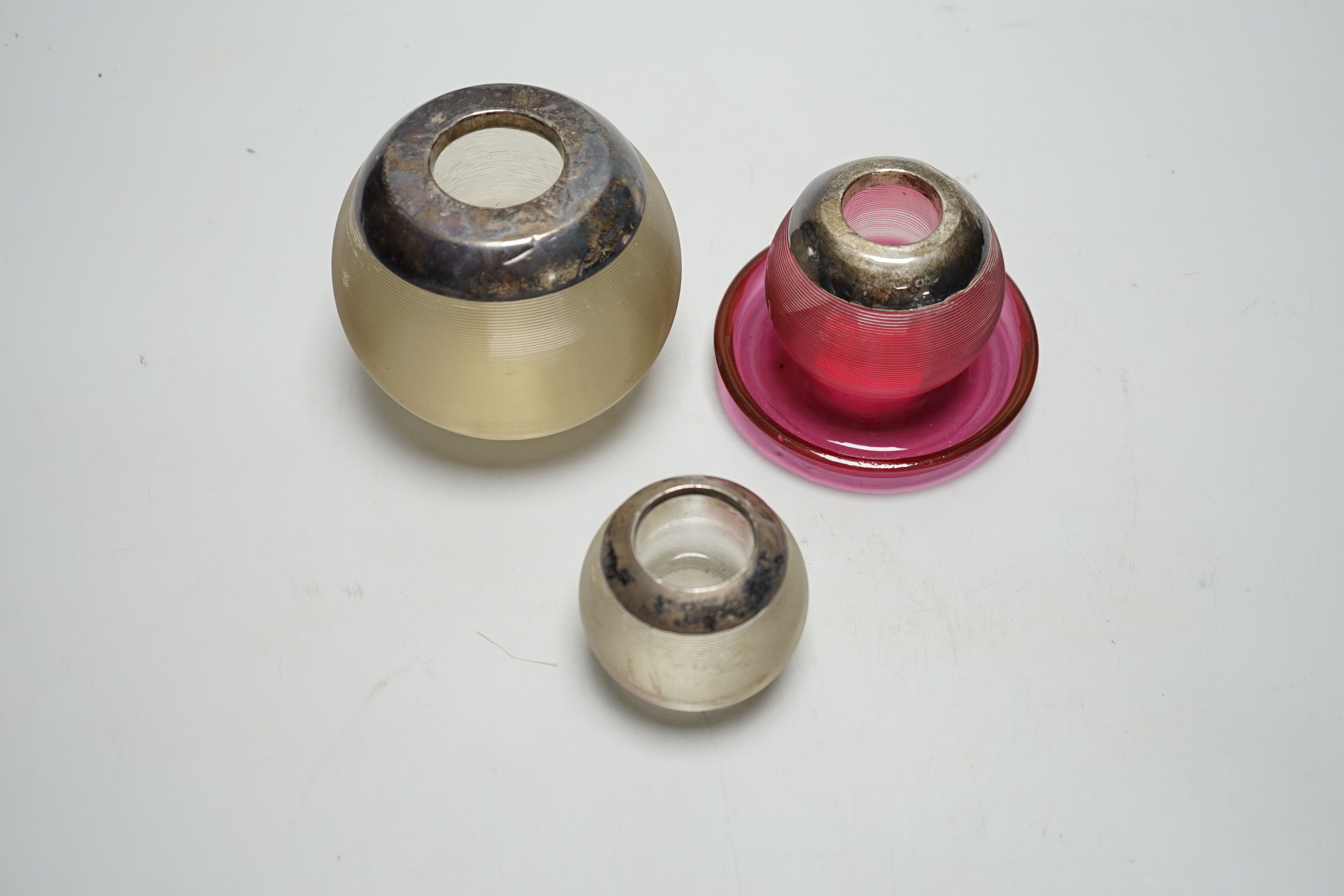 Three assorted late 19th/early 20th century silver mounted ribbed glass match strikes, including cranberry glass, largest Birmingham, 1925, 8.7cm, smallest Birmingham, 1899.
